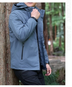 Détail d'une veste d'extérieur coupe-vent avec poches zippées dans un décor de forêt