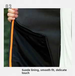 Detail of soft black fleece lining with orange trim for men's outdoor jacket