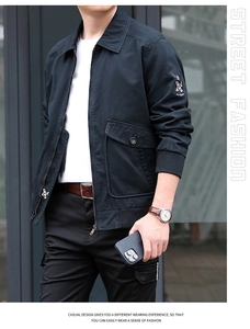 Detail view of navy blue cotton jacket featuring vintage embroidered sleeve badge and rib cuffs