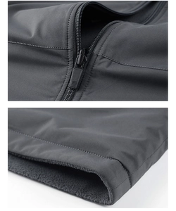 Detailed close-up of windproof dark gray outdoor jacket with warm fleece lining and stitching