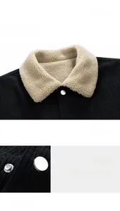 Detail of retro black corduroy jacket with sherpa collar and silver snap buttons