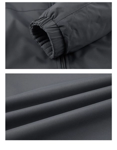 Detail of elastic cuffs and warm fleece lining on a dark grey outdoor windproof jacket