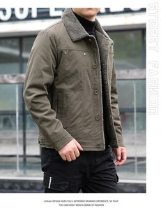 Detail showing grey sherpa collar on olive green winter jacket with chest pockets