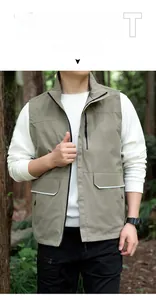 Detail of khaki outdoor vest showing functional multi-pockets and reflective strips