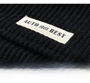Detailed macro view of black corduroy fabric texture with a premium brand woven label