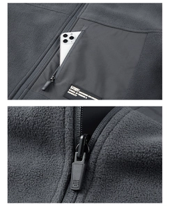 Detail of zippered chest pocket on grey fleece jacket showing large storage capacity