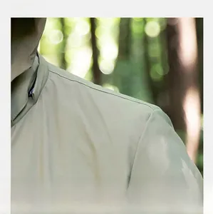 Detailed macro view of the high-density reinforced shoulder stitching on the light green jacket