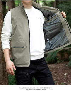 Detailed view of grey-green outdoor vest with cargo pockets and stand collar