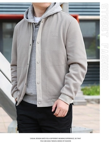 Detailed close-up of men's beige waffle knit jacket showing texture and street fashion style