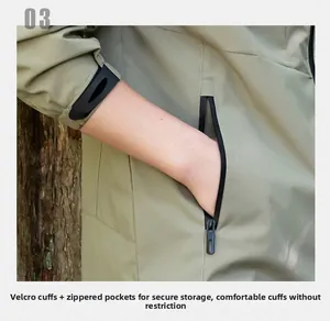 Detail of adjustable velcro cuffs and waterproof zipper pocket on men's gray jacket