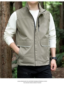 Detail view of khaki outdoor utility vest featuring stand-up collar and multi-zipper pockets