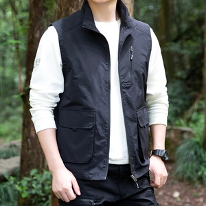 Men's black outdoor multi-pocket utility vest with stand-up collar in nature background