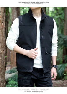 Close-up of black outdoor vest featuring stand collar, zip pockets and waterproof fabric
