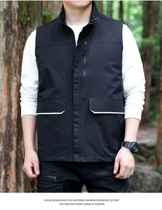 Detail of black outdoor vest featuring multi-pockets, stand collar, and windproof fabric
