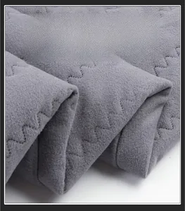 Detail shot of the thick fleece lining and zigzag quilting on gray thermal trousers