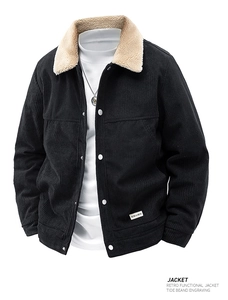 Detailed view of the black corduroy texture and white sherpa fleece collar on men's jacket