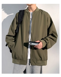 Detail of army green bomber jacket with ribbed collar and high-quality windproof texture