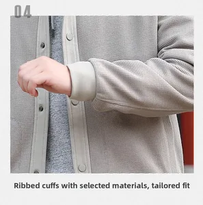 Detail of light gray waffle texture jacket featuring ribbed cuffs and silver snap buttons
