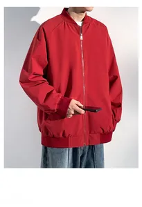 Detail of red padded bomber jacket featuring metal zipper and ribbed cuffs and collar