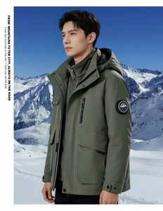 Detail of olive green outdoor 3-in-1 jacket featuring a mountain badge on the sleeve
