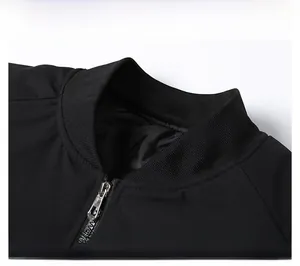 Detail of ribbed knit collar and silver metal zipper on men's black bomber jacket