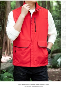 Close-up of a red outdoor vest featuring a stand collar and multiple functional pockets