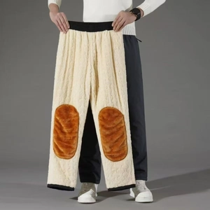 Detail of plush lamb wool trousers featuring brown knee patches and windproof cuffs