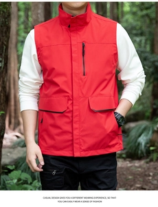 Detail of red outdoor utility vest for men with stand collar and zipper pockets