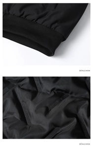 Detailed view of black quilted inner fabric and rib-knit cuffs on a winter jacket