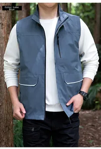 Detail of lake blue outdoor vest featuring vertical zip pocket and reflective trim pockets