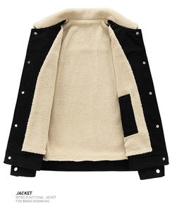 Detail view of black corduroy jacket showing soft cream faux shearling lining and inner pocket