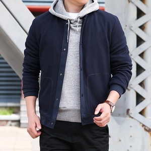 Men's navy waffle knit jacket with stand collar paired with a grey hooded sweatshirt