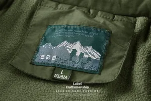 Close-up of winter jacket fleece collar with mountain logo label and size information
