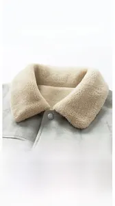 Macro view of suede jacket collar with sherpa fleece lining and matte metal snap button