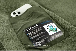 Detail of internal pocket on green fleece jacket showing space for a smartphone