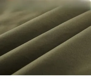 Detail of olive green twill fabric showing tight texture and natural cotton sheen