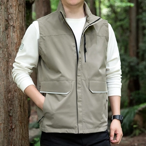 Men's outdoor khaki utility vest with multi-pockets and stand collar in forest setting