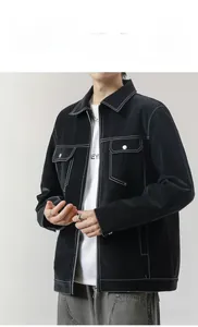 Detail of black leather jacket showing white contrast stitching and large flap chest pockets
