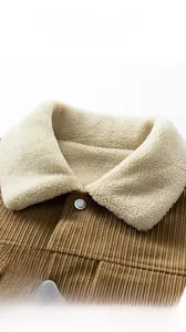 Close-up of brown corduroy jacket featuring white sherpa fleece collar and metal buttons