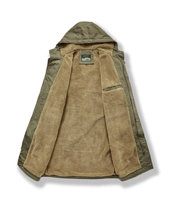 Detailed view of heavy-duty military green jacket with thick beige sherpa fleece lining