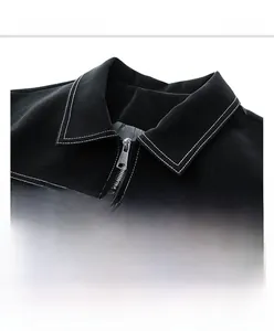 Detail view of black leather jacket with contrast white stitching and flap pockets