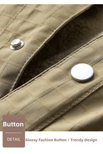 Detail of metal button on khaki waffle texture jacket with warm fleece lining