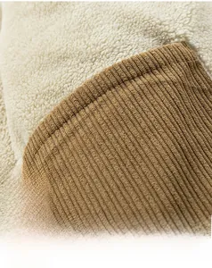Detail of inner pocket showing warm white shearling lining and brown corduroy trim