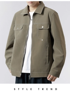 Detailed view of olive leather jacket with white contrast stitching and chest pockets