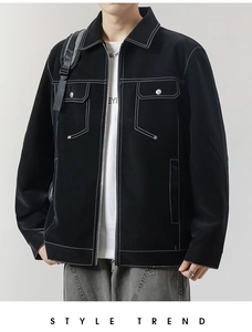 Detail view of contrast white stitching on black jacket with flap pockets and metal zipper