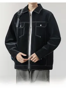 Detail of black lapel jacket with white contrast stitching and chest pockets