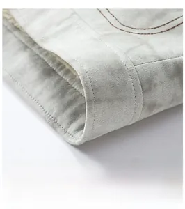 Detail of grey faux suede jacket featuring double-stitched hem and warm fleece lining