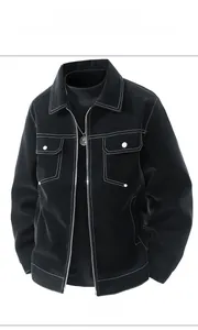 Detail of black faux leather jacket featuring contrast white stitching and chest pockets
