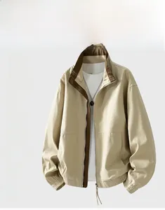 Detail of men's beige jacket with stand collar and brown contrast zipper stitching