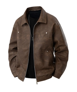 Detailed macro view of vintage brown faux leather texture and silver zipper of pilot jacket